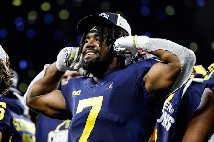 Michigan running back Donovan Edwards (7) waves at fans after the Wolverines won the Big Ten Championship after defeating Purdue 43-22 at Lucas Oil Stadium in Indianapolis, Ind., on Saturday, Dec. 3, 2022.